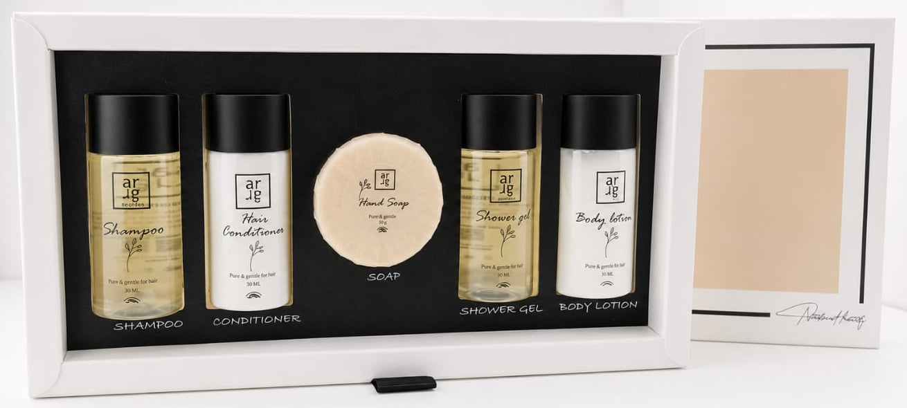 Set of skincare products in a black box with a white background