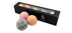 Bath bombs in various colors with a black box labeled 'ar' on a white background