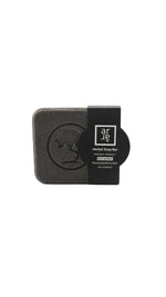 Black soap bar with a label on a white background